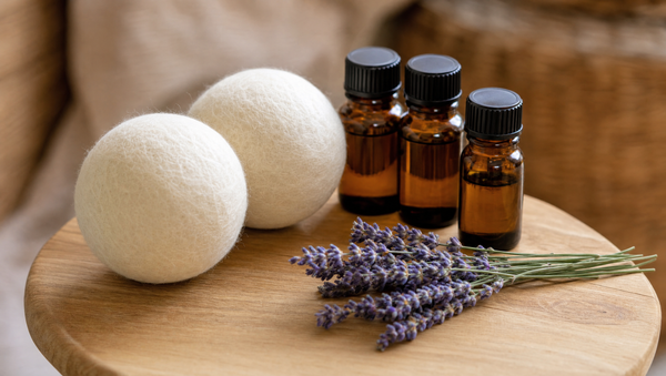 Wool dryer balls with amber essential oil bottles and lavender